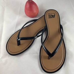 Black sandals, flats or thongs, size 12, never worn.